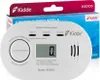 A Kidde carbon monoxide detector is shown in front of its packaging. Podgląd zdjęcia produktu
