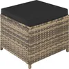 A square rattan ottoman with a black cushion on top, shown from a slightly elevated angle against a white background. Produktbild-Vorschau