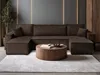 A modern living room with a large sectional sofa and a round coffee table. Produktbild-Vorschau