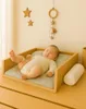 A baby sleeping on a changing pad on a dresser. Produktbild-Vorschau