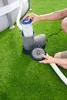 A person is shown inserting a filter into a pool pump on a green lawn next to an above-ground pool. Produktbild-Vorschau