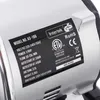 A close-up of a label on a silver-colored air compressor. Podgląd zdjęcia produktu