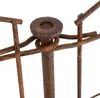 A close-up view of a rusty metal fence post with a circular cap and wire elements. Produktbild-Vorschau