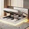A modern bedroom with a white upholstered bed frame open to reveal storage space underneath, illuminated by LED lighting around the base. Produktbild-Vorschau