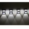 Four black wall-mounted solar LED lights are shown on a dark wall, casting light downwards. Anteprima dell’immagine prodotto