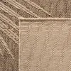 A close-up view of a woven rug with a geometric pattern. Voir les images du produit