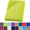 A folded fitted sheet in a bright lime green color is shown against a white background. Below the sheet, a row of smaller color swatches are displayed. Produktbild-Vorschau
