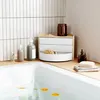A bathroom scene with a bathtub and various bath products on a wooden surface. Náhled obrázku produktu