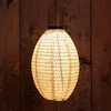 A paper lantern hangs against a wooden wall. Anteprima dell’immagine prodotto