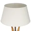 A close-up view of a white lampshade on a wooden lamp base. Podgląd zdjęcia produktu