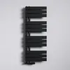 A black radiator is mounted on a white wall. Produktbild-Vorschau