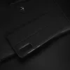 A black flip cover for a smartphone is shown on a black surface. Produktbild-Vorschau