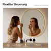A woman is applying makeup in front of a round LED mirror. Produktbild-Vorschau