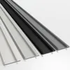 Four different colored strips of material are laid out diagonally on a white surface. Produktbild-Vorschau