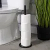 A toilet paper holder with several rolls of toilet paper next to a toilet. Voir les images du produit