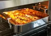 A roasting pan filled with food is inside an oven. Produktbild-Vorschau