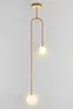 A modern gold pendant light with two frosted glass globes against a white background. Produktbild-Vorschau