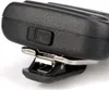 A close-up view of a black electronic device, likely a microphone or speaker, with a metal clip attached. Náhled obrázku produktu
