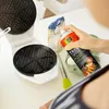 A person is using a spray to grease a waffle maker before making waffles. Produktbild-Vorschau