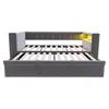 A grey upholstered daybed with a pull-out trundle bed is shown from the front, with the mattress slats visible. The headboard has built-in LED lighting. Náhľad obrázku produktu