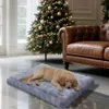A dog sleeping on a dog bed in front of a Christmas tree and a leather sofa. Podgląd zdjęcia produktu
