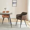 Two dining chairs are shown in a room setting with a table. Náhled obrázku produktu