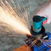 A hand is using a mini angle grinder to cut a metal object clamped in a vise, creating a shower of sparks. Náhled obrázku produktu