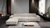 A modern living room with a large sectional sofa, fireplace, and coffee table. Náhľad obrázku produktu