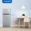 A refrigerator is shown next to a dining table with chairs in a room. Produktbild-Vorschau