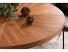 A close-up view of a round wooden dining table with decorative balls and greenery on it. Anteprima dell’immagine prodotto