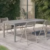 An outdoor dining set with a gray table and beige chairs on a wooden deck, surrounded by lush greenery. Podgląd zdjęcia produktu