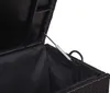 Close-up view of the inside of a black storage box, showing the gas strut mechanism for lifting the lid. Produktbild-Vorschau