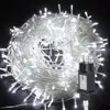 A tangled ball of white LED string lights with a black power adapter in the foreground. Produktbild-Vorschau