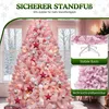 A pink Christmas tree decorated with ornaments and lights, set in a festive indoor scene with a window showing a snowy landscape. Produktbild-Vorschau