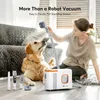 A woman is using a grooming tool on a golden retriever dog next to a white and orange pet grooming vacuum. Produktbild-Vorschau
