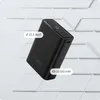A black power bank is shown floating against a geometric white and light gray background. Voir les images du produit