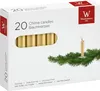 A box of gold chime candles with a sprig of evergreen branches and a single lit candle. Anteprima dell’immagine prodotto