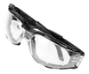 A pair of clear safety glasses with black frames, shown against a white background. Produktbild-Vorschau