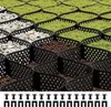 A close-up view of a landscape grid system filled with grass, gravel, and soil, with fasteners shown below. Podgląd zdjęcia produktu