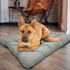 A dog is lying on a large gray dog mat in a living room. Anteprima dell’immagine prodotto