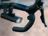 Close-up of a bicycle handlebar with a front light and a remote control. Produktbild-Vorschau