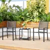 Two black metal chairs and a small side table are set up on a wooden deck, surrounded by lush green plants. Produktbild-Vorschau