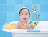 A baby is taking a bath and playing with bath toys. Produktbild-Vorschau