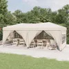 A party tent set up outdoors with tables and chairs inside. Produktbild-Vorschau