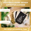 A flat lay of items for creating a personalized advent calendar, including stickers, bags, and clothespins, arranged on a wooden surface with scattered faux snow and festive greenery. Anteprima dell’immagine prodotto