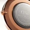 Close-up of the back of a Daniel Wellington watch, showing engraved details and the brand logo. Produktbild-Vorschau