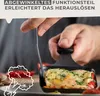 A hand is using a black spatula to remove a cooked raclette dish from a black pan. There are decorative drawings of vegetables on the left side of the image. Produktbild-Vorschau