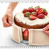 A cake is being removed from a baking mold by hands. Produktbild-Vorschau