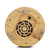 The underside of a wooden aroma diffuser with a fan grille and power input. Produktbild-Vorschau