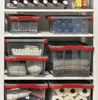 Storage boxes stacked on shelves in a closet or pantry. Produktbild-Vorschau